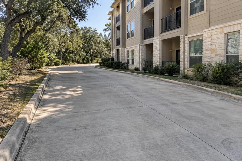 Concrete fire lane beside a multi-storey apartment building