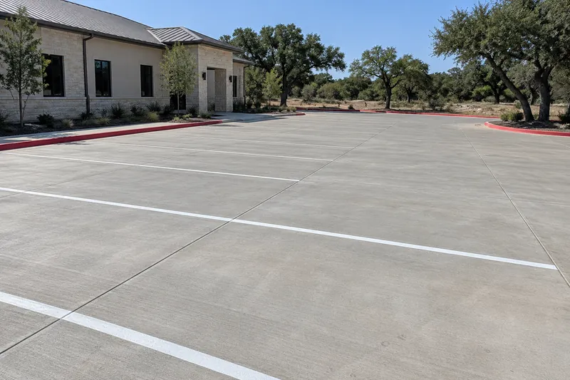 New concrete parking lot with painted stalls and a fire lane
