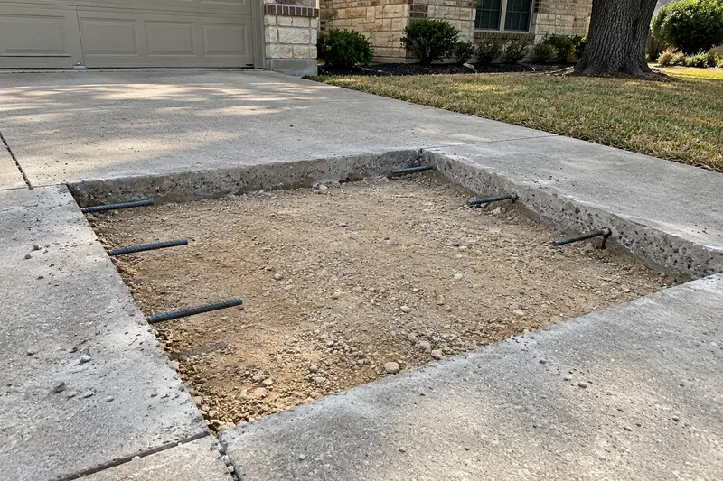 Driveway panel saw-cut out, with dowels drilled into the old edge