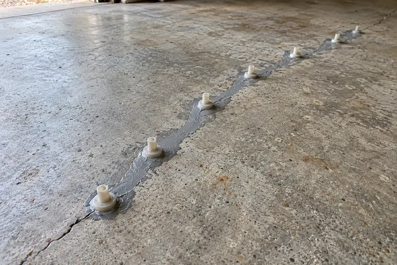 Injection ports set along a crack for epoxy repair
