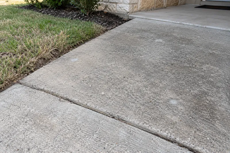 Small drilled injection holes, patched, in a lifted slab