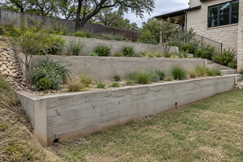 Stepped concrete retaining walls on a sloped lot